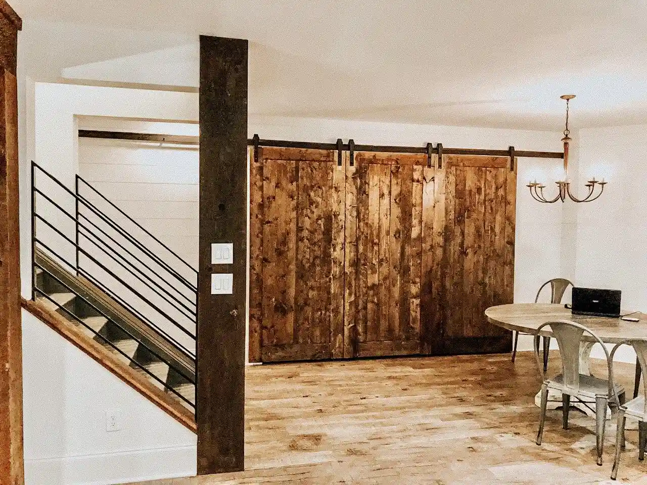 Basement remodel with barn doors and open staircase in Marietta, GA
